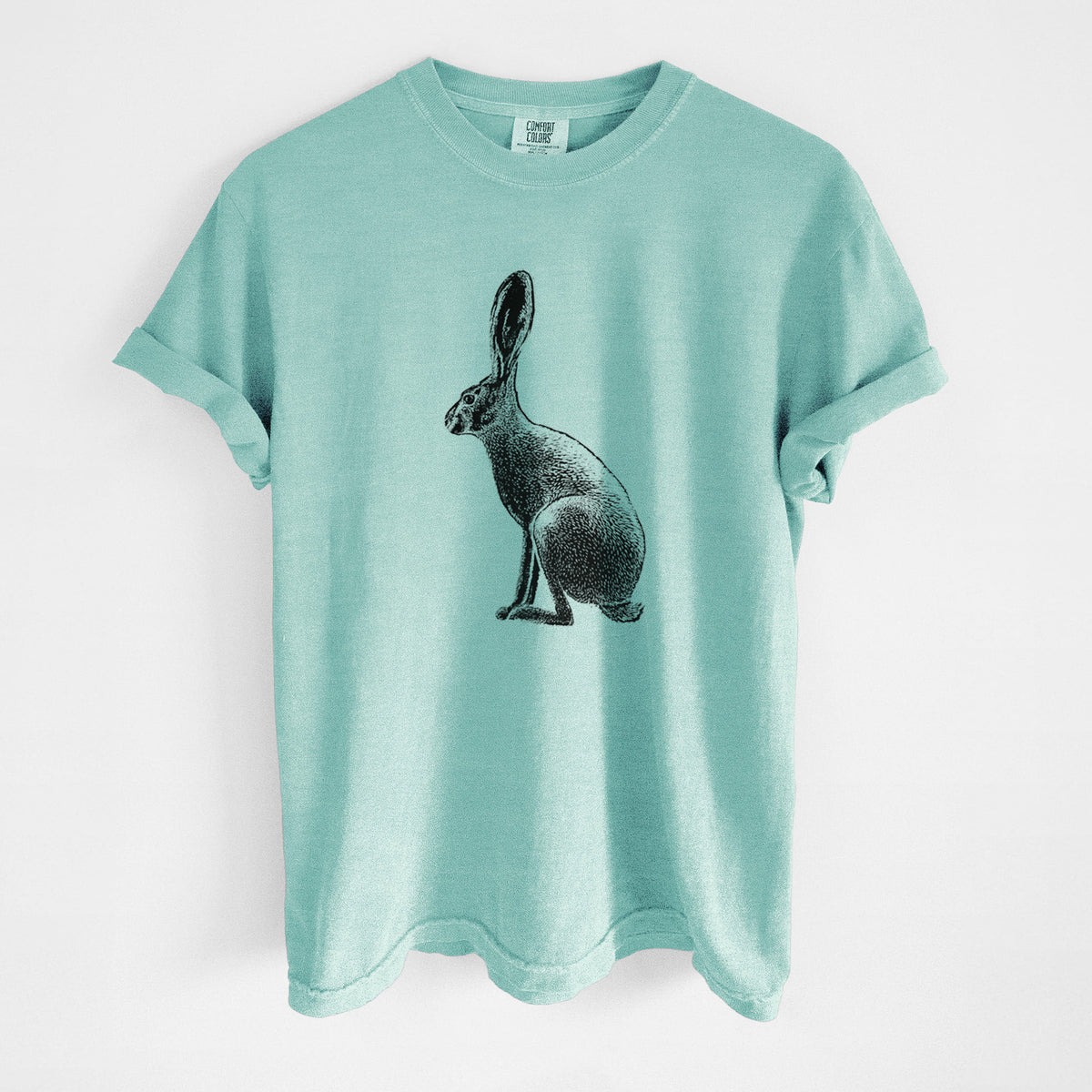 Chalky mint Comfort Colors t-shirt laid flat, printed with a detailed black ink illustration of a black-tailed jackrabbit sitting in profile with tall ears.