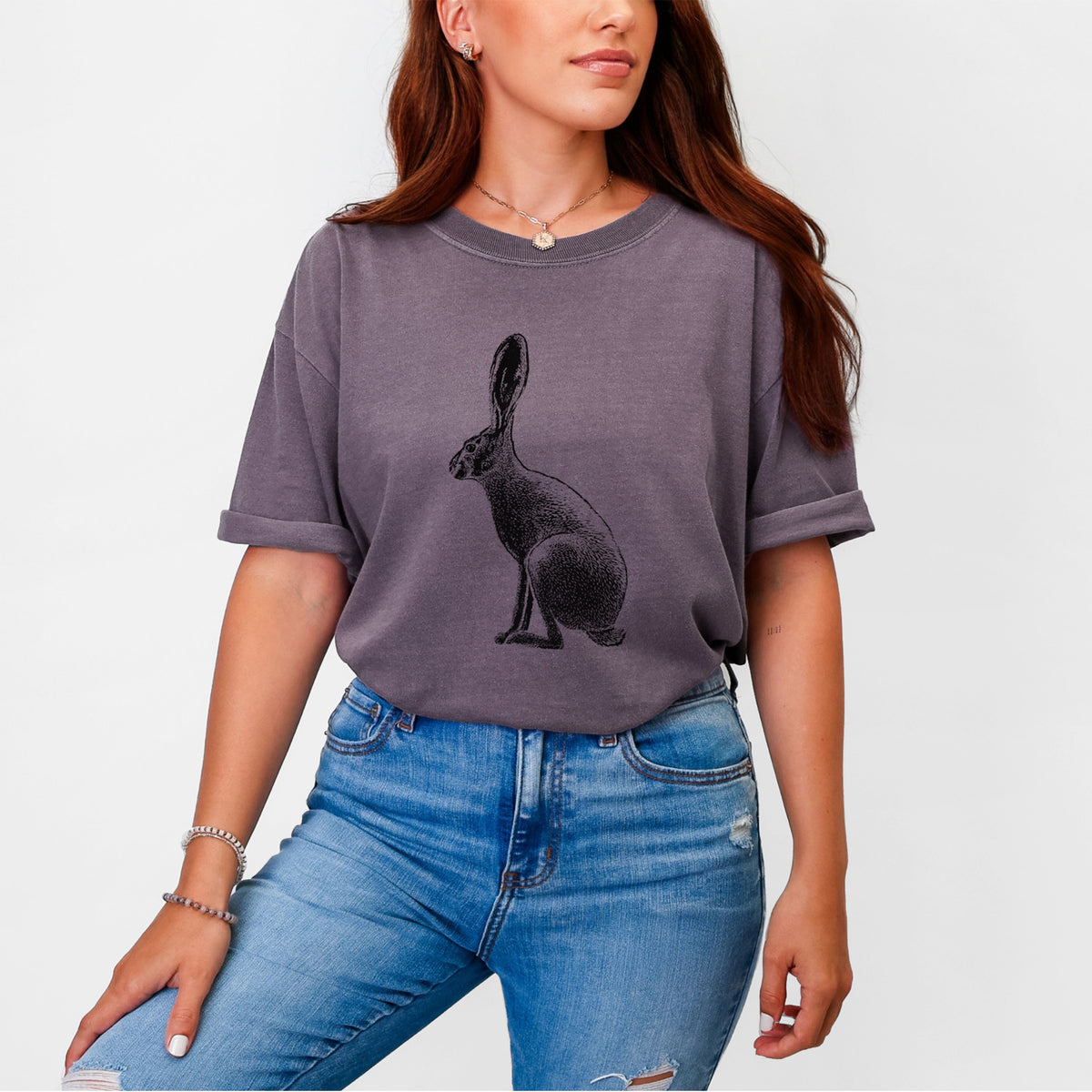 Woman wearing a Comfort Colors t-shirt printed with a detailed black ink illustration of a black-tailed jackrabbit sitting in profile with tall ears.