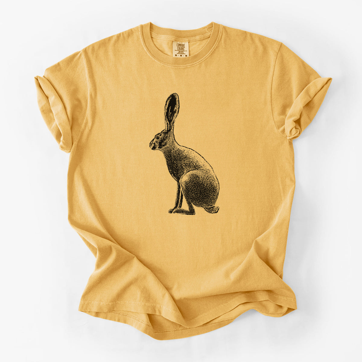 Golden wheat yellow Comfort Colors t-shirt laid flat, printed with a detailed black ink illustration of a black-tailed jackrabbit sitting in profile with tall ears.