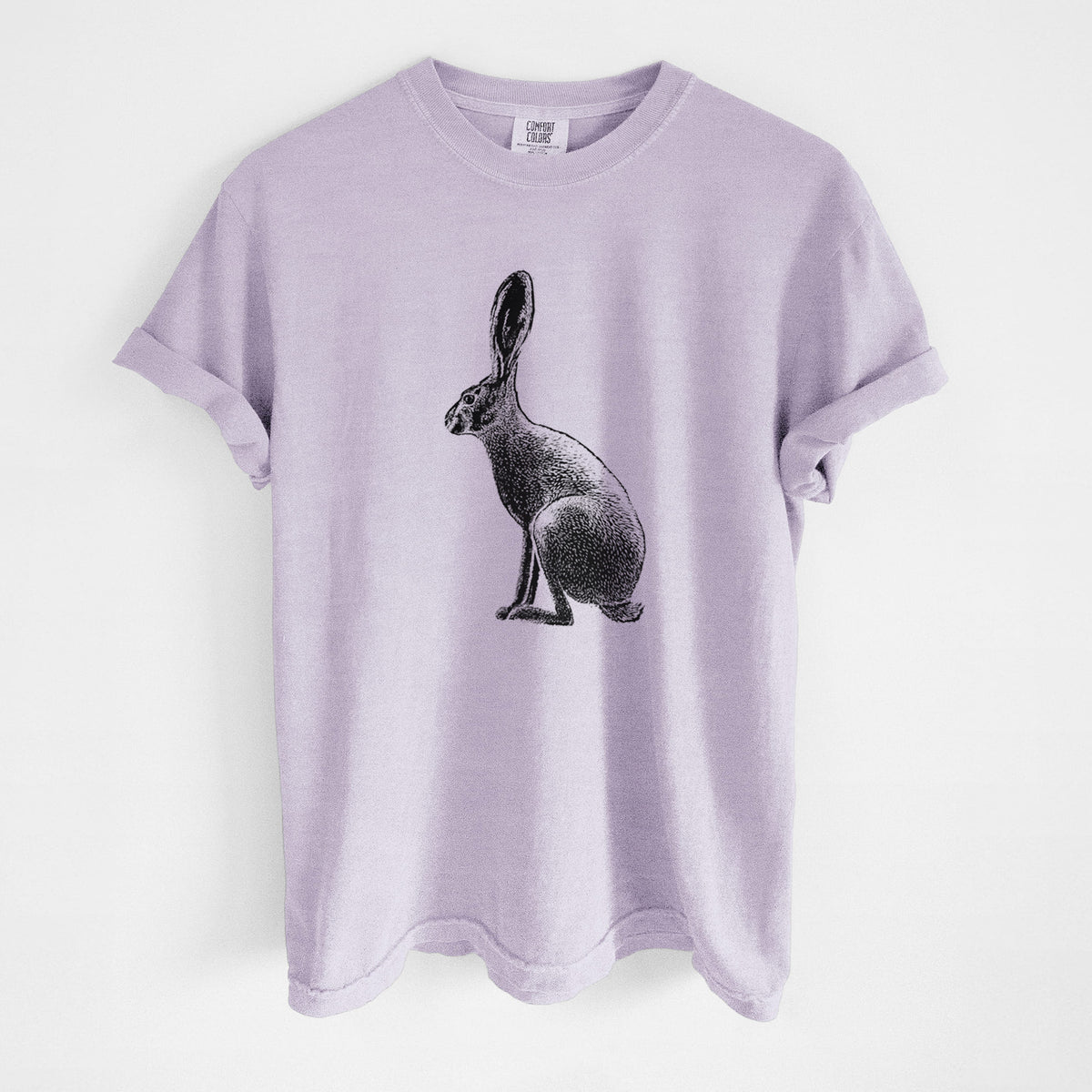Orchid purple Comfort Colors t-shirt laid flat, printed with a detailed black ink illustration of a black-tailed jackrabbit sitting in profile with tall ears.