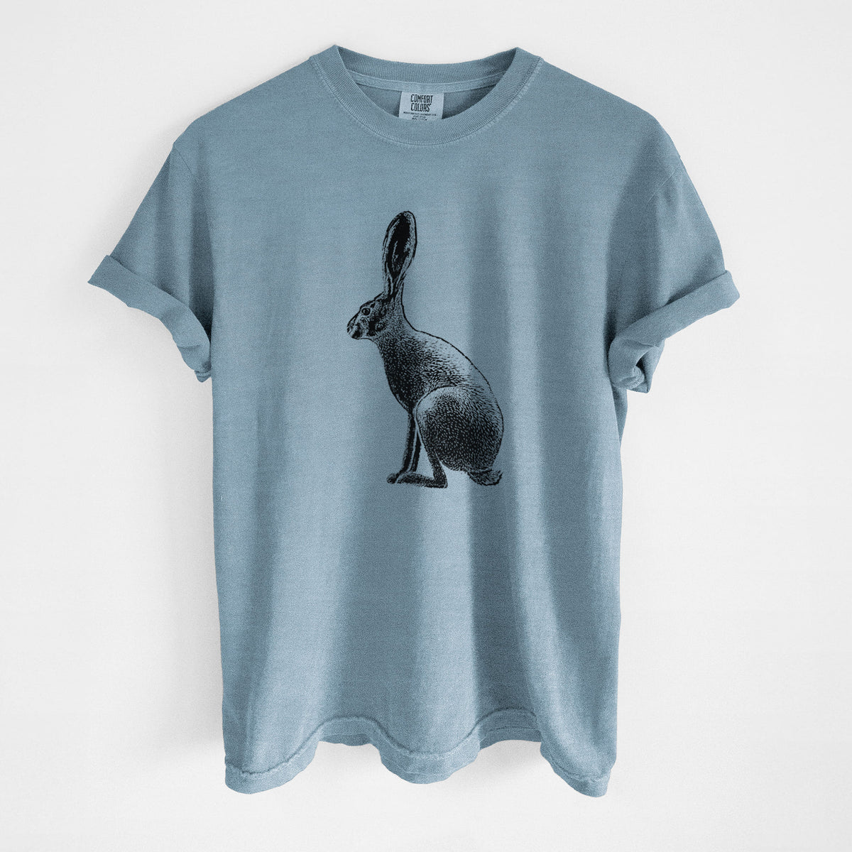Steel blue Comfort Colors t-shirt laid flat, printed with a detailed black ink illustration of a black-tailed jackrabbit sitting in profile with tall ears.