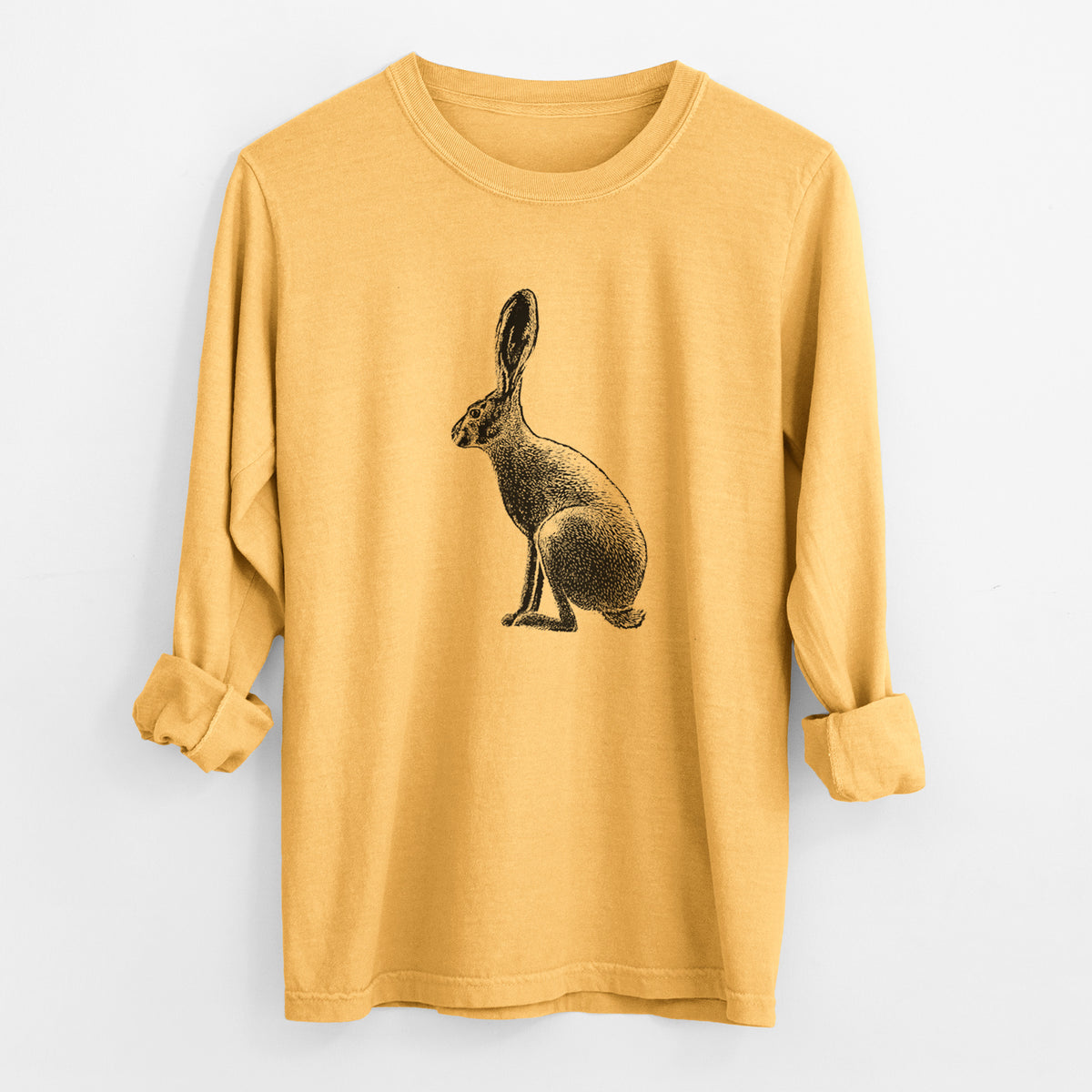Golden wheat yellow Comfort Colors long sleeve shirt laid flat with the cuffs rolled, printed with a detailed black ink illustration of a black-tailed jackrabbit sitting in profile with tall ears.