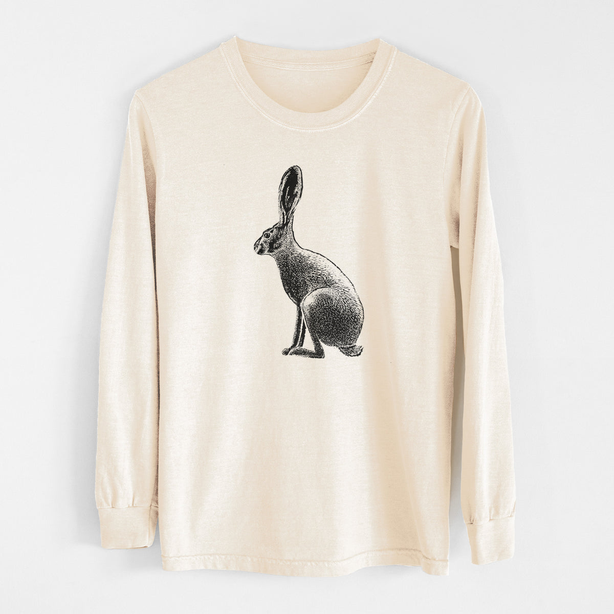 Ivory Comfort Colors long sleeve shirt laid flat, printed with a detailed black ink illustration of a black-tailed jackrabbit sitting in profile with tall ears.