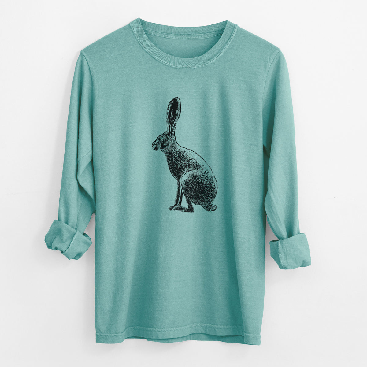 Reef green Comfort Colors long sleeve shirt laid flat with the cuffs rolled, printed with a detailed black ink illustration of a black-tailed jackrabbit sitting in profile with tall ears.