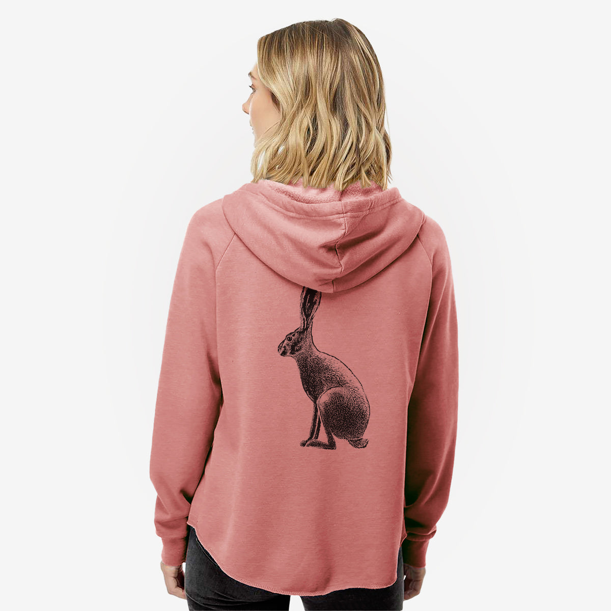 Woman wearing a dusty rose women's Cali Wave zip-up sweatshirt printed with a detailed black ink illustration of a black-tailed jackrabbit sitting in profile with tall ears, seen from behind.