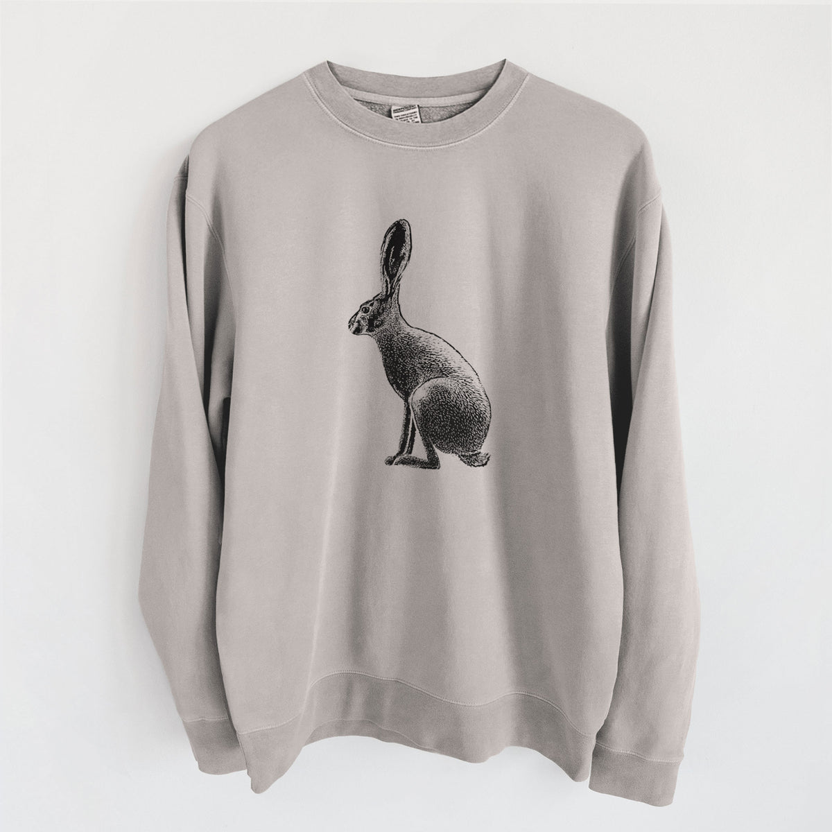 Cement grey pigment dyed crewneck sweatshirt laid flat, printed with a detailed black ink illustration of a black-tailed jackrabbit sitting in profile with tall ears.