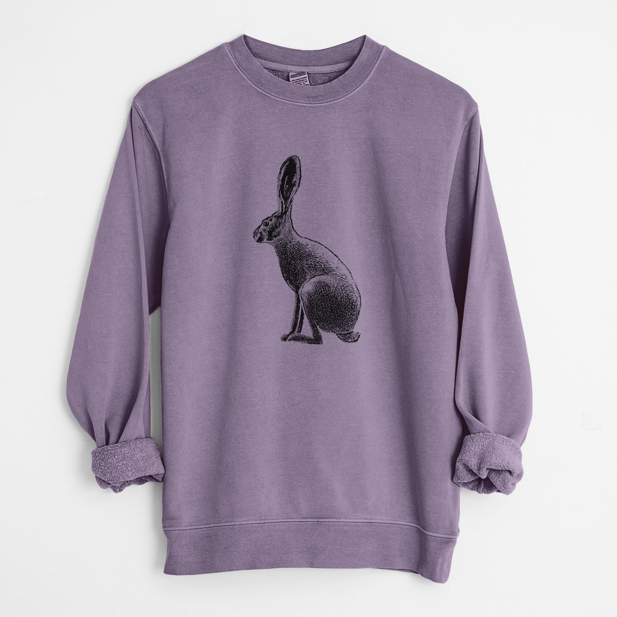 Plum purple pigment dyed crewneck sweatshirt laid flat with the sleeves rolled, printed with a detailed black ink illustration of a black-tailed jackrabbit sitting in profile with tall ears.