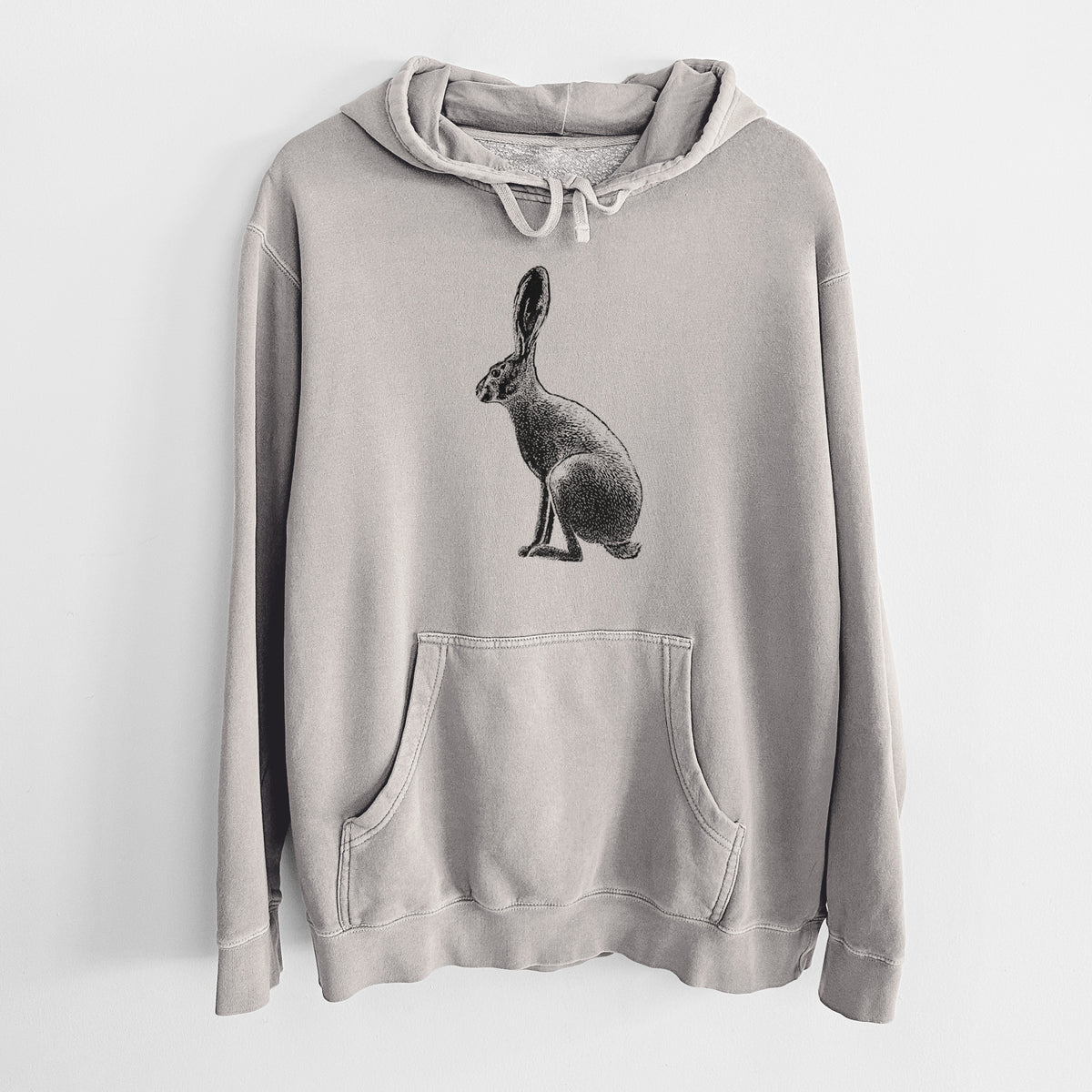 Cement grey pigment dyed hoodie laid flat, printed with a detailed black ink illustration of a black-tailed jackrabbit sitting in profile with tall ears.