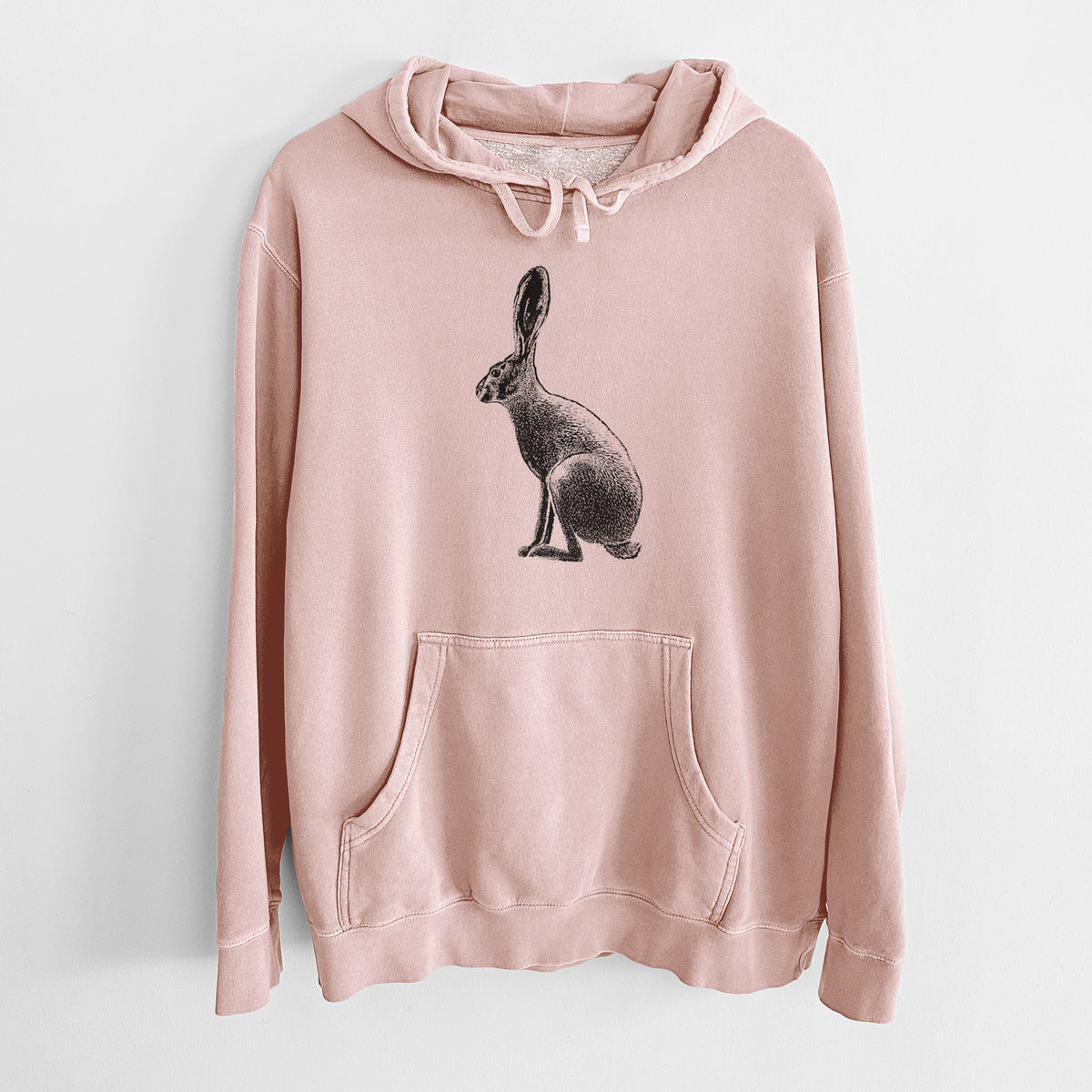 Dusty pink pigment dyed hoodie laid flat, printed with a detailed black ink illustration of a black-tailed jackrabbit sitting in profile with tall ears.