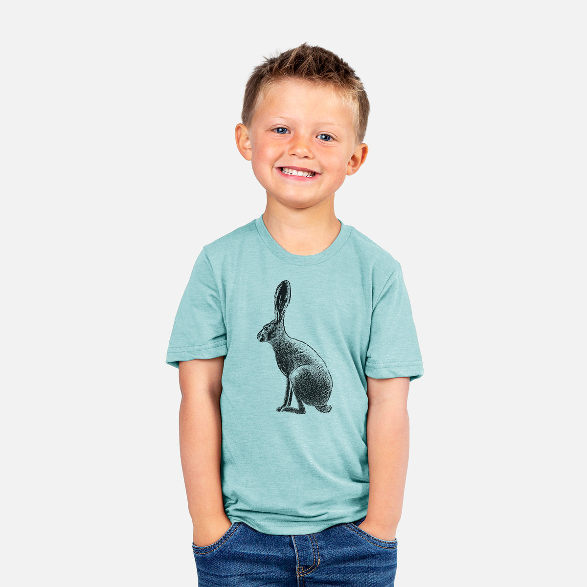 Smiling boy wearing a youth t-shirt printed with a detailed black ink illustration of a black-tailed jackrabbit sitting in profile with tall ears.