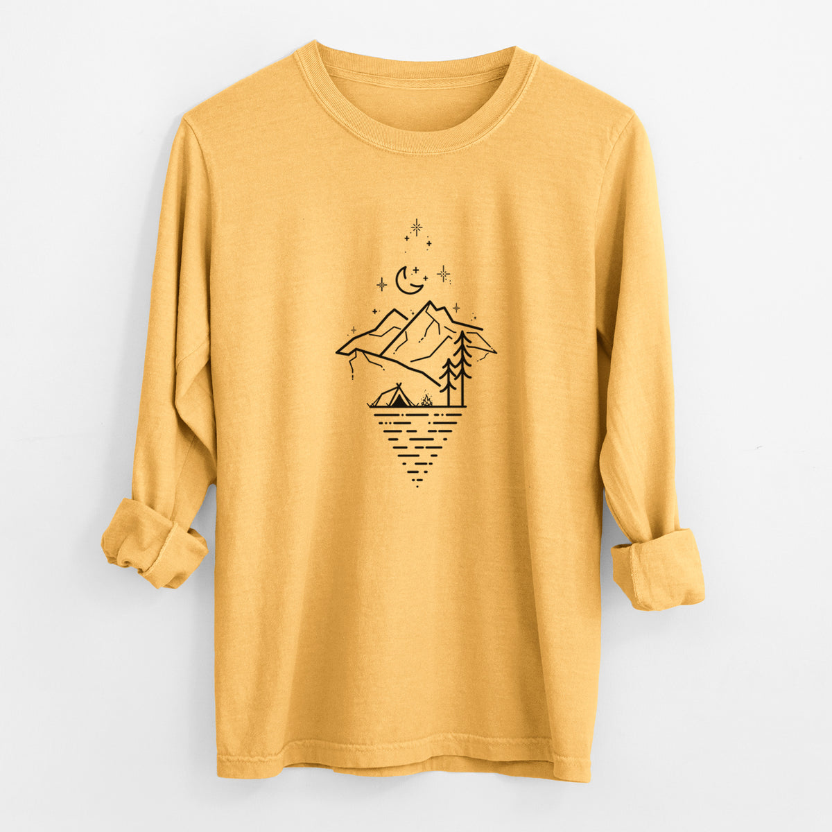 Golden wheat yellow Comfort Colors long sleeve shirt laid flat with the cuffs rolled, printed with black line art of mountains, pine trees, a crescent moon and stars above a lake inside a diamond outline.