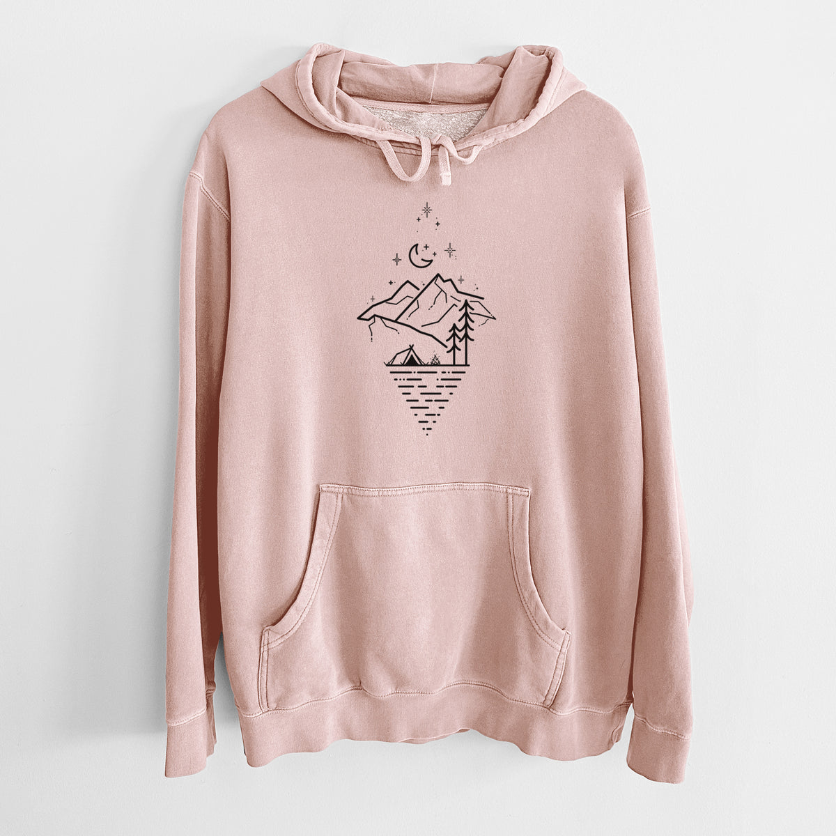Dusty pink pigment dyed hoodie laid flat, printed with black line art of mountains, pine trees, a crescent moon and stars above a lake inside a diamond outline.
