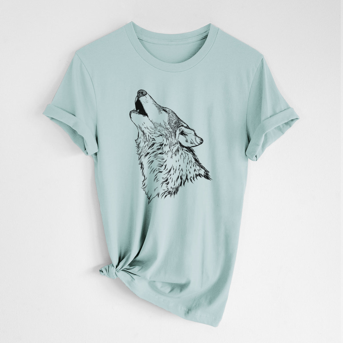 Dusty blue lightweight cotton t-shirt laid flat with the sleeves rolled, printed with a detailed black ink illustration of a grey wolf's head and shoulders, howling upward.