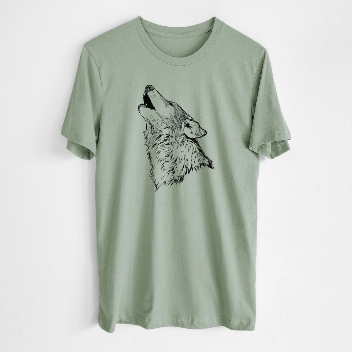 Sage green lightweight cotton t-shirt laid flat, printed with a detailed black ink illustration of a grey wolf's head and shoulders, howling upward.
