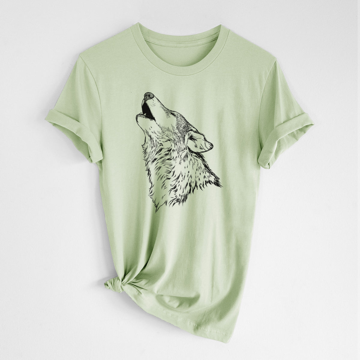 Spring green lightweight cotton t-shirt laid flat with the sleeves rolled, printed with a detailed black ink illustration of a grey wolf's head and shoulders, howling upward.