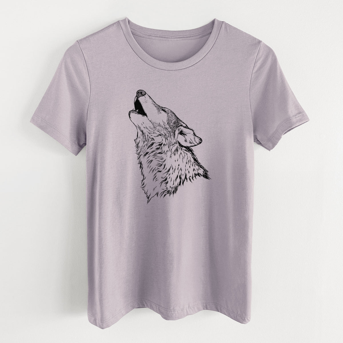 Light violet women's relaxed fit cotton t-shirt laid flat, printed with a detailed black ink illustration of a grey wolf's head and shoulders, howling upward.