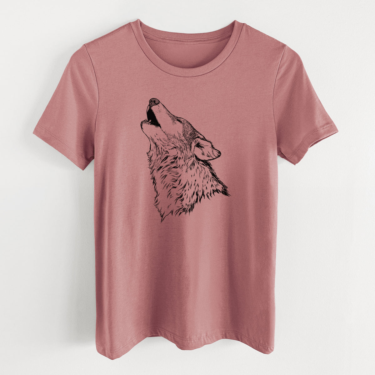 Mauve pink women's relaxed fit cotton t-shirt laid flat, printed with a detailed black ink illustration of a grey wolf's head and shoulders, howling upward.