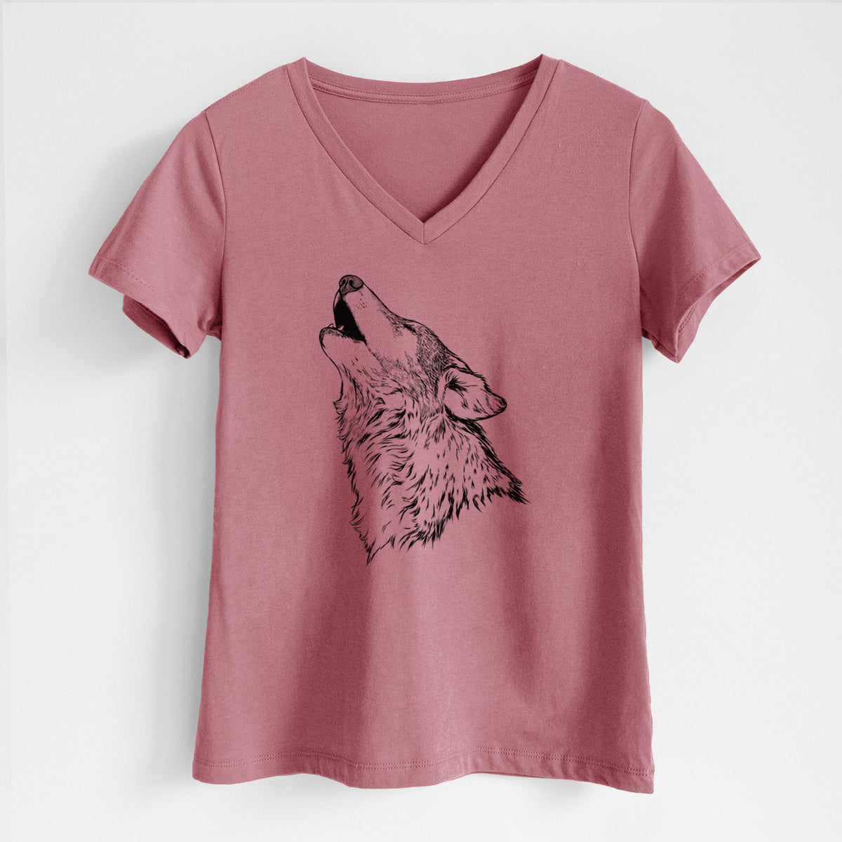 Mauve pink women's relaxed fit cotton V-neck t-shirt laid flat, printed with a detailed black ink illustration of a grey wolf's head and shoulders, howling upward.