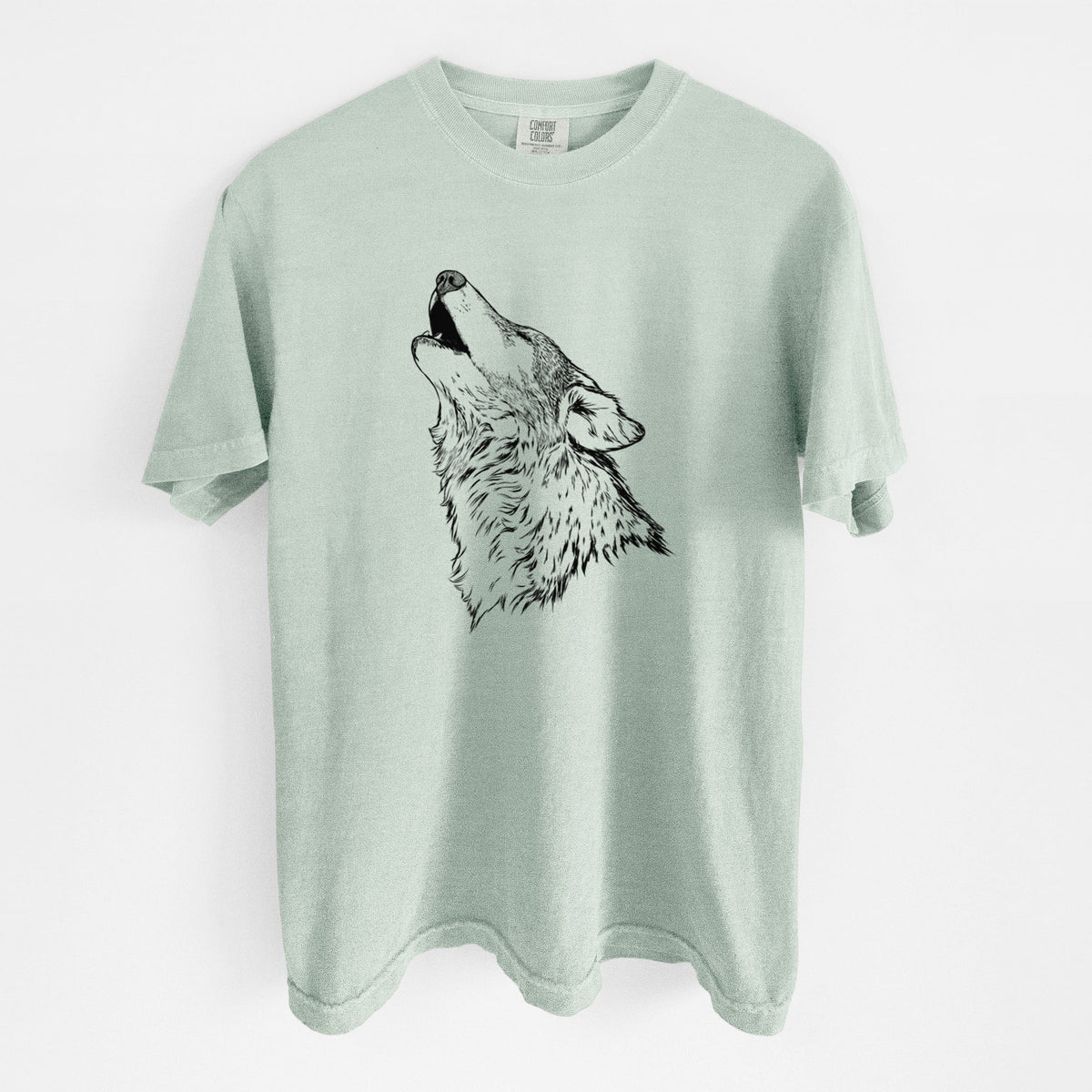 Bay green Comfort Colors t-shirt laid flat, printed with a detailed black ink illustration of a grey wolf's head and shoulders, howling upward.