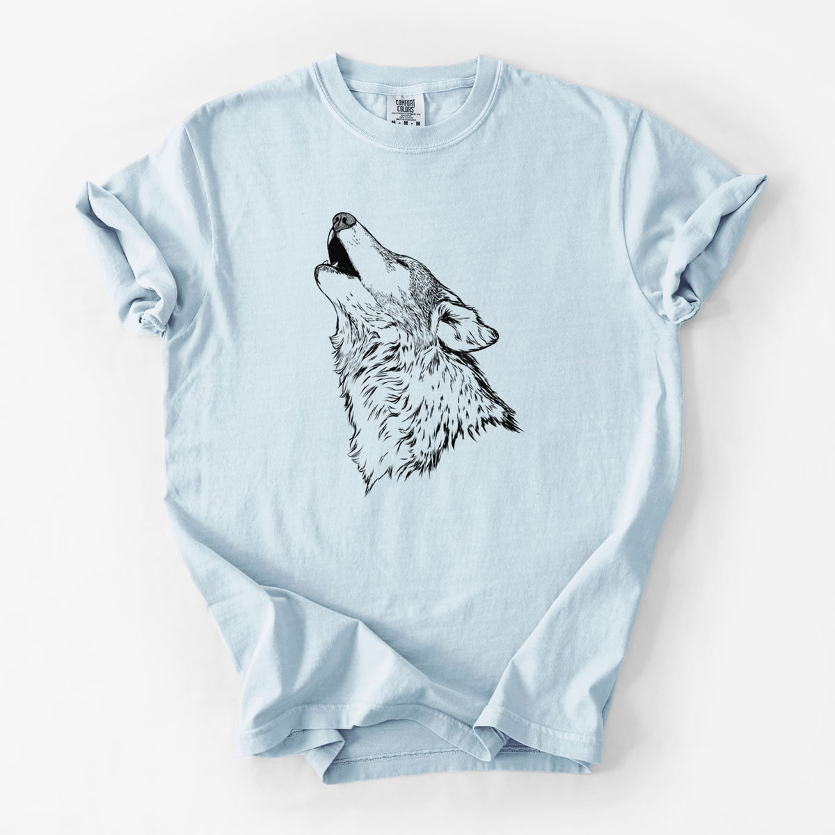 Chambray blue Comfort Colors t-shirt laid flat, printed with a detailed black ink illustration of a grey wolf's head and shoulders, howling upward.