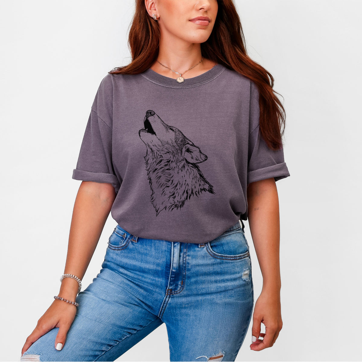 Woman wearing a Comfort Colors t-shirt printed with a detailed black ink illustration of a grey wolf's head and shoulders, howling upward.