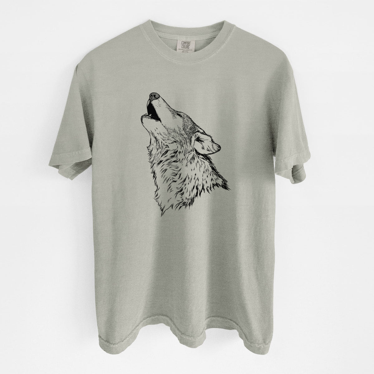 Sandstone beige Comfort Colors t-shirt laid flat, printed with a detailed black ink illustration of a grey wolf's head and shoulders, howling upward.