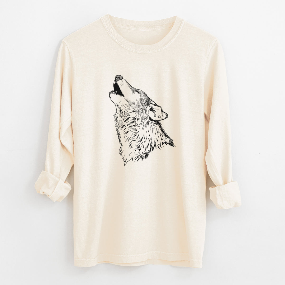 Ivory Comfort Colors long sleeve shirt laid flat with the cuffs rolled, printed with a detailed black ink illustration of a grey wolf's head and shoulders, howling upward.