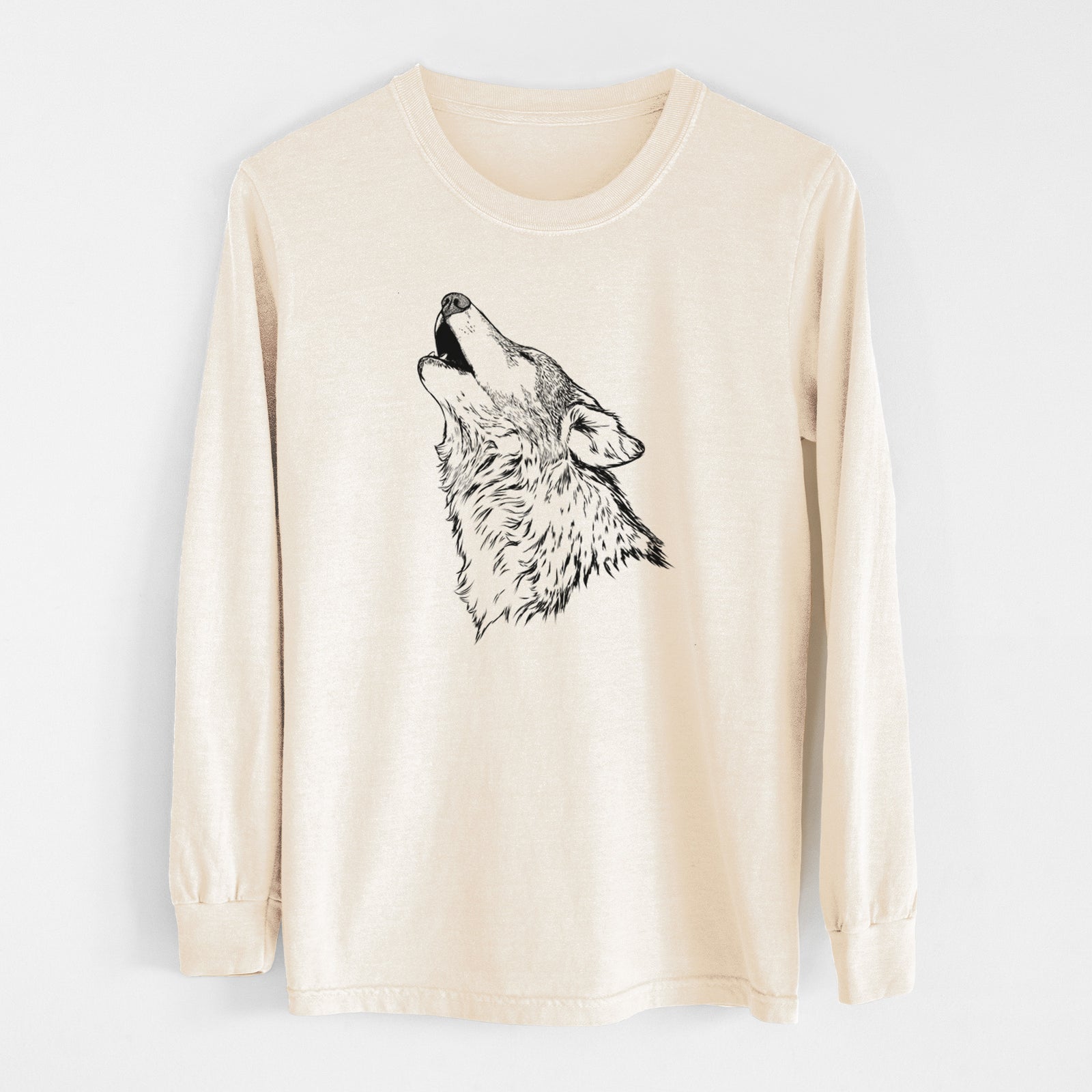 Ivory Comfort Colors long sleeve shirt laid flat, printed with a detailed black ink illustration of a grey wolf's head and shoulders, howling upward.