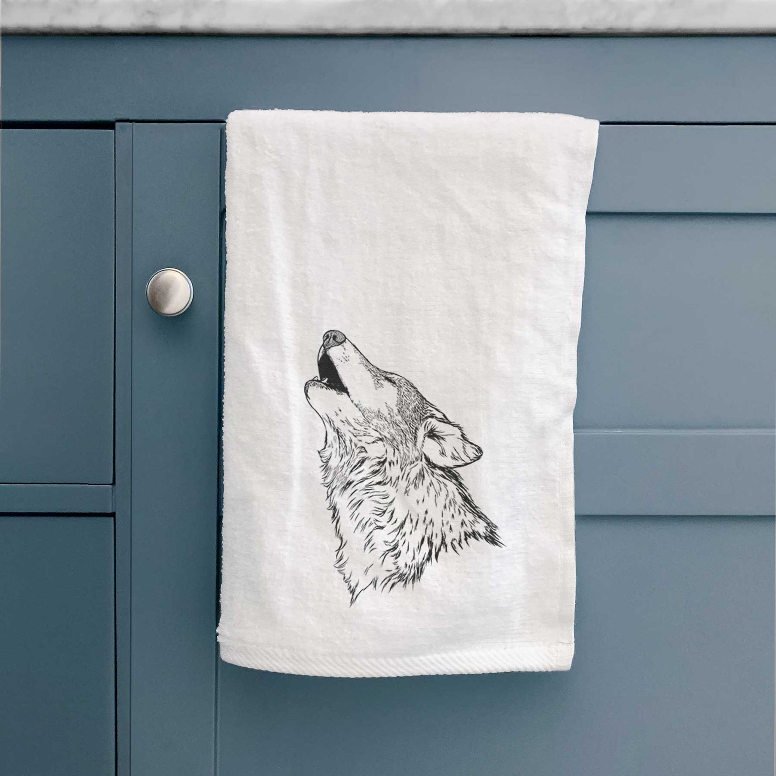 White hand towel printed with a detailed black ink illustration of a grey wolf's head and shoulders, howling upward.