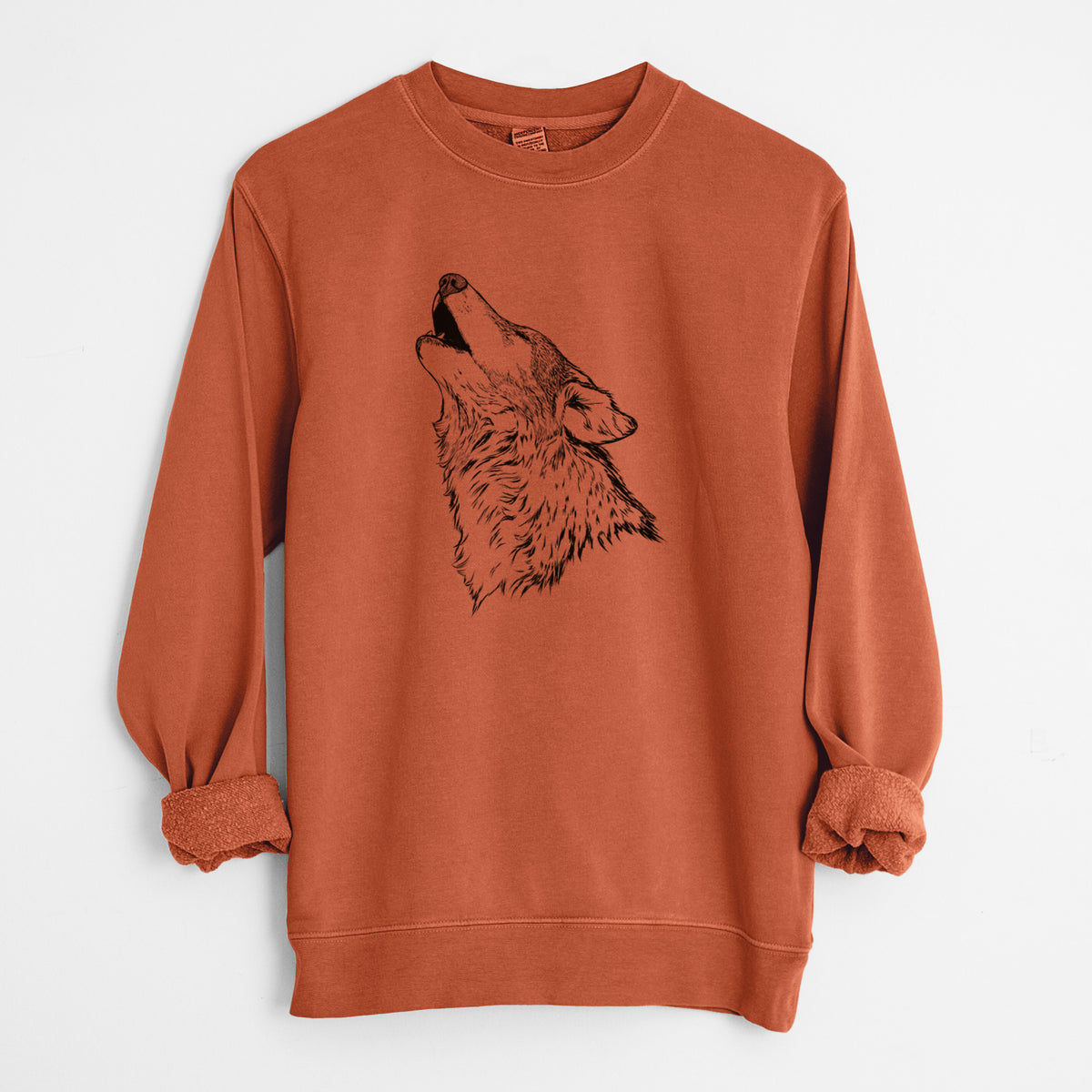 Amber orange pigment dyed crewneck sweatshirt laid flat with the sleeves rolled, printed with a detailed black ink illustration of a grey wolf's head and shoulders, howling upward.