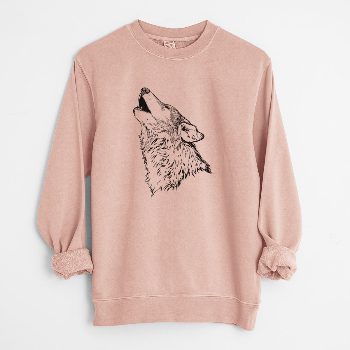 Dusty pink pigment dyed crewneck sweatshirt laid flat with the sleeves rolled, printed with a detailed black ink illustration of a grey wolf's head and shoulders, howling upward.