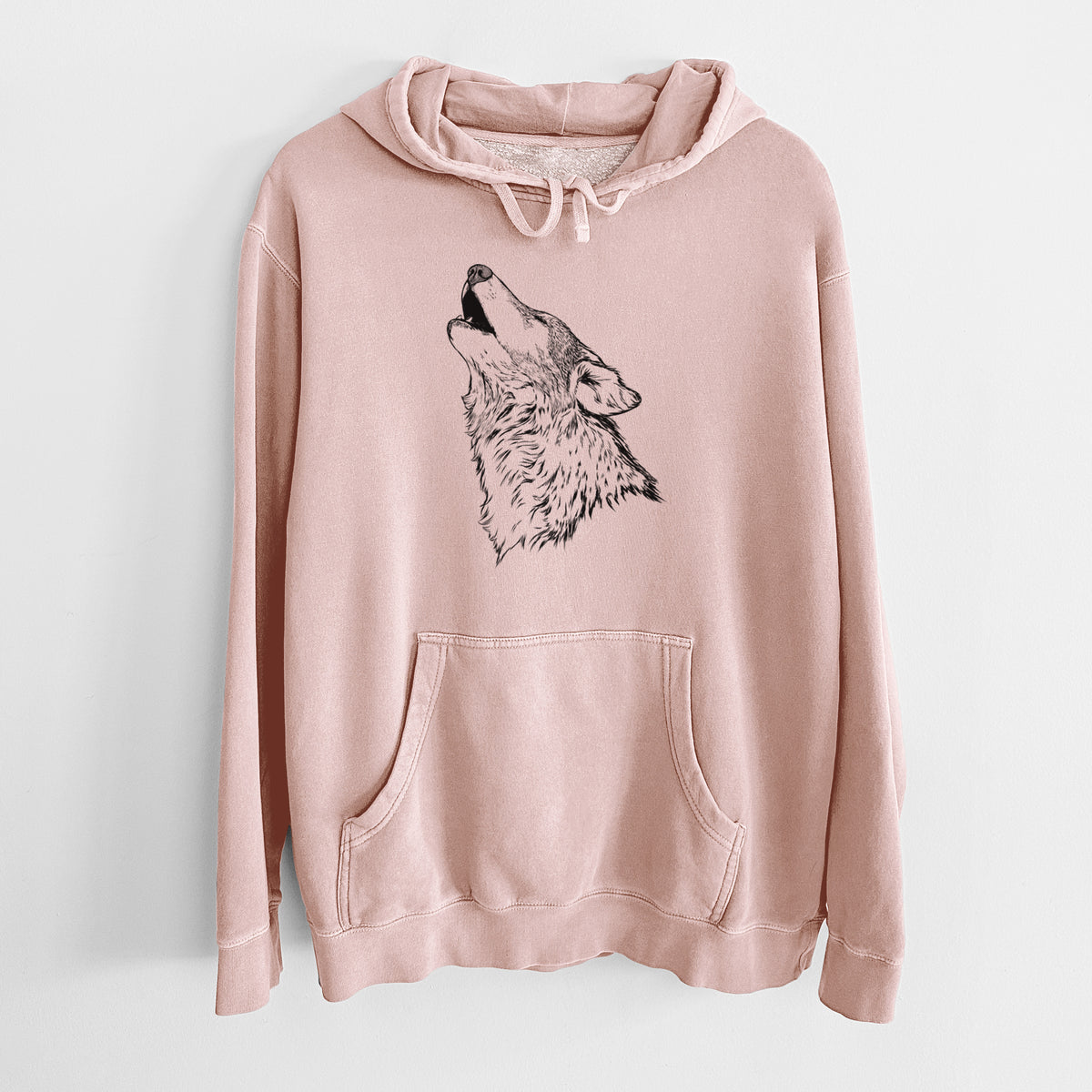 Dusty pink pigment dyed hoodie laid flat, printed with a detailed black ink illustration of a grey wolf's head and shoulders, howling upward.