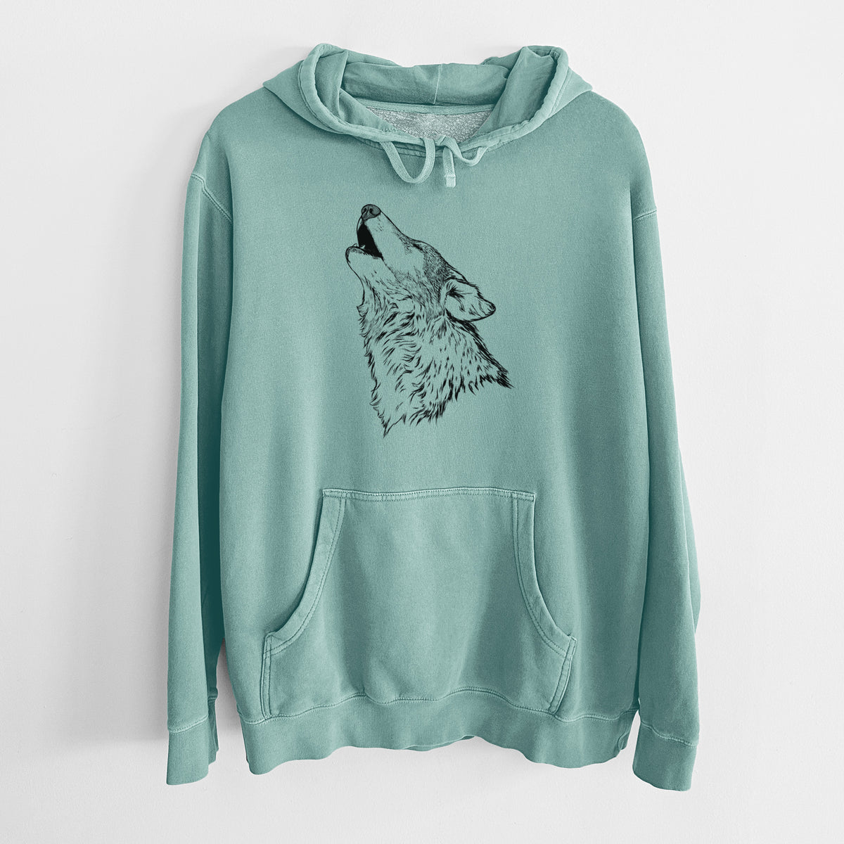 Mint green pigment dyed hoodie laid flat, printed with a detailed black ink illustration of a grey wolf's head and shoulders, howling upward.