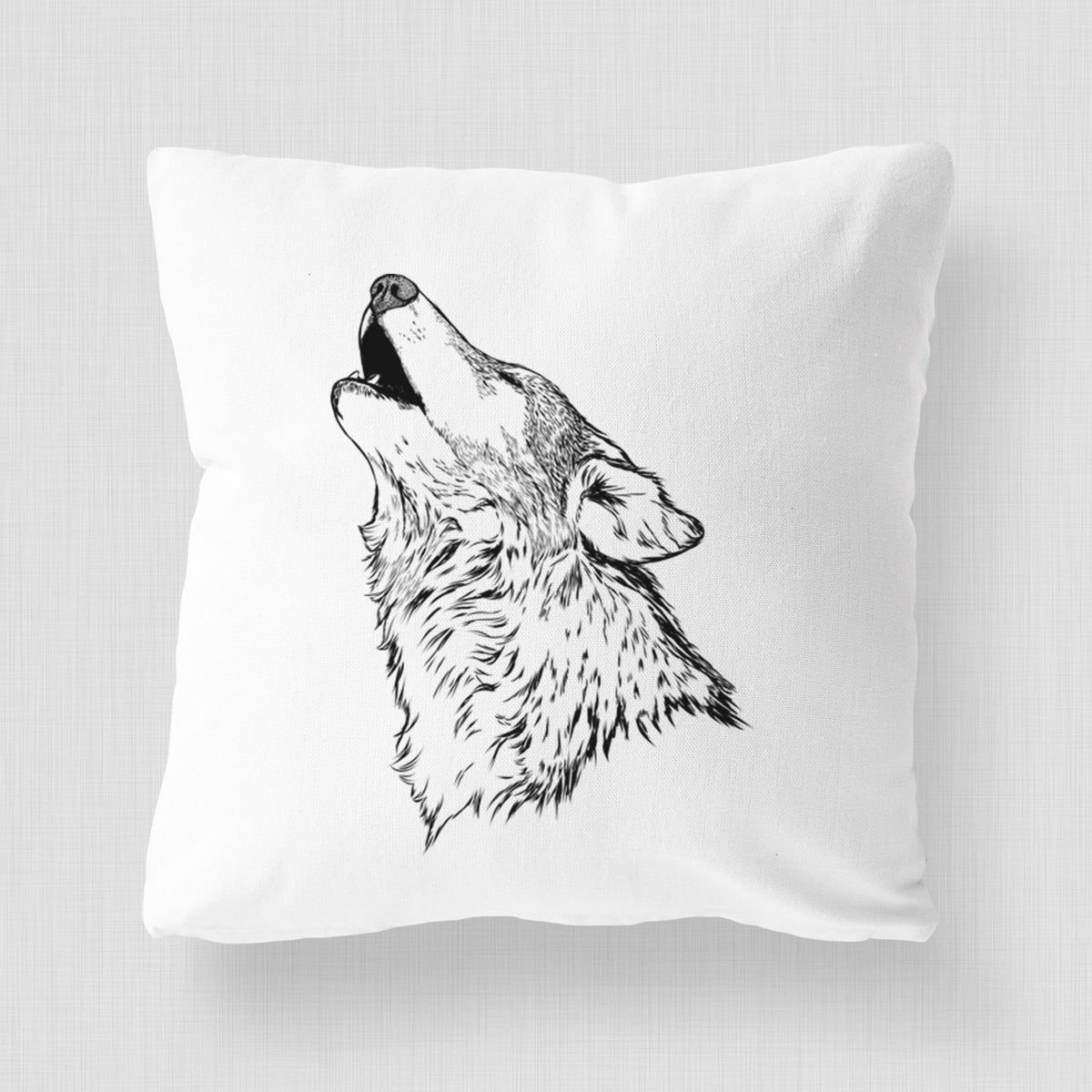 White pillow cover printed with a detailed black ink illustration of a grey wolf's head and shoulders, howling upward.