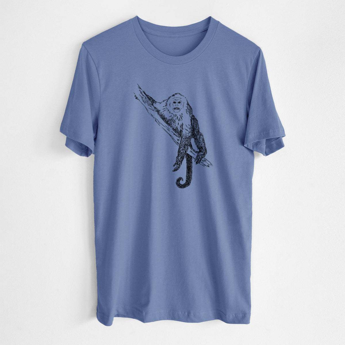 Blue bell lightweight cotton t-shirt laid flat, printed with a detailed black ink illustration of a capuchin monkey climbing a branch.
