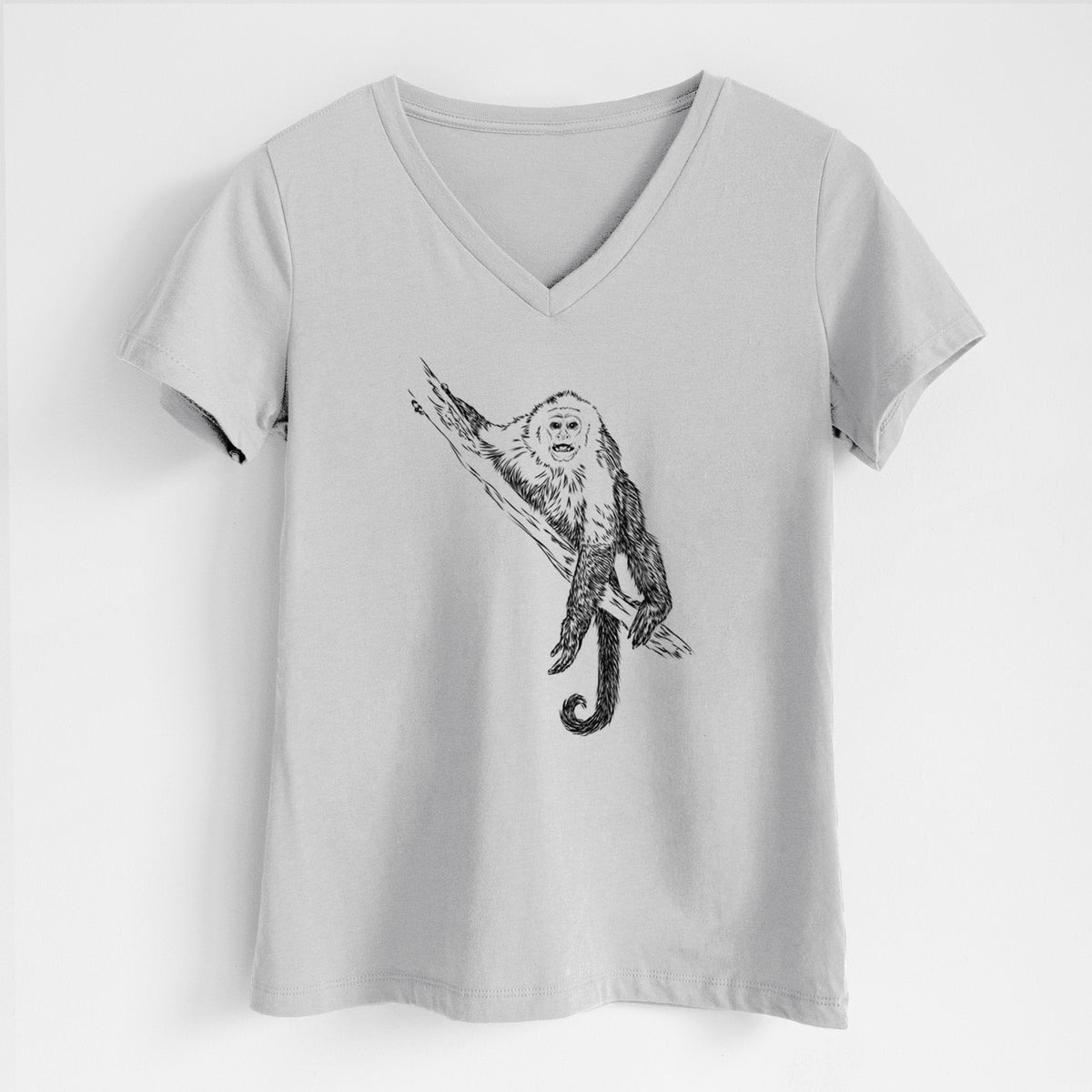 Lunar grey women's relaxed fit cotton V-neck t-shirt laid flat, printed with a detailed black ink illustration of a capuchin monkey climbing a branch.
