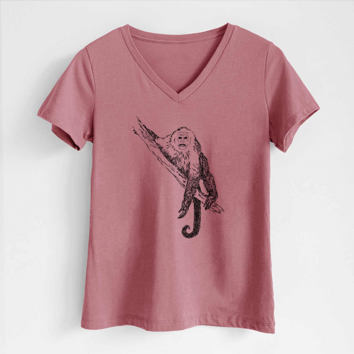 Mauve pink women's relaxed fit cotton V-neck t-shirt laid flat, printed with a detailed black ink illustration of a capuchin monkey climbing a branch.