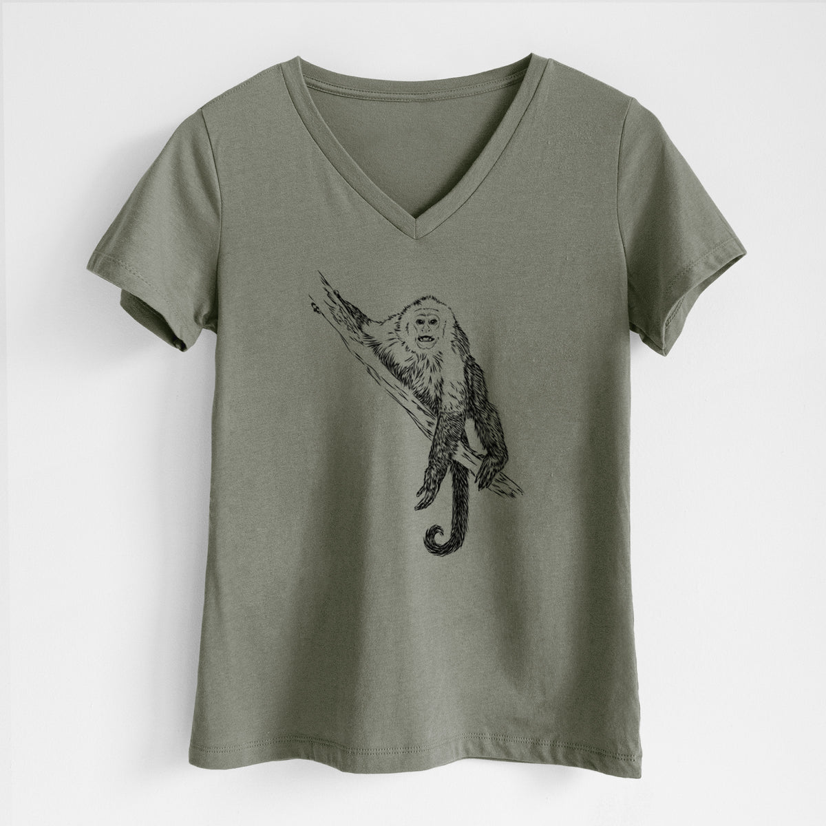 Military green women's relaxed fit cotton V-neck t-shirt laid flat, printed with a detailed black ink illustration of a capuchin monkey climbing a branch.