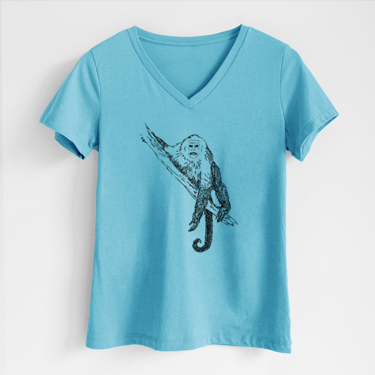 Turquoise women's relaxed fit cotton V-neck t-shirt laid flat, printed with a detailed black ink illustration of a capuchin monkey climbing a branch.