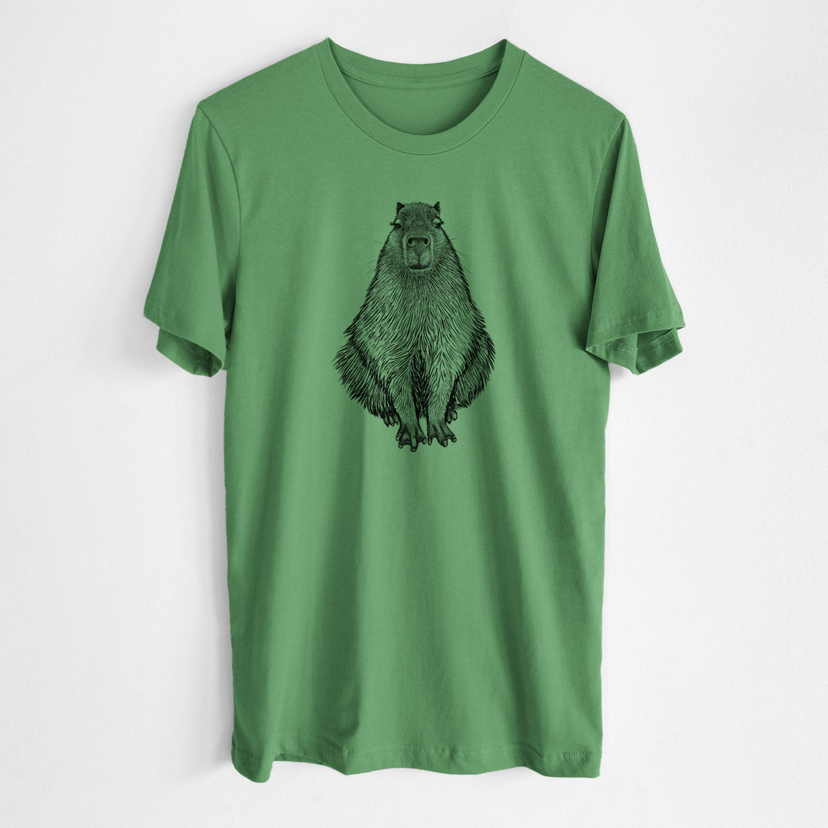 Leaf green lightweight cotton t-shirt laid flat, printed with a detailed black ink illustration of a capybara sitting and facing forward.