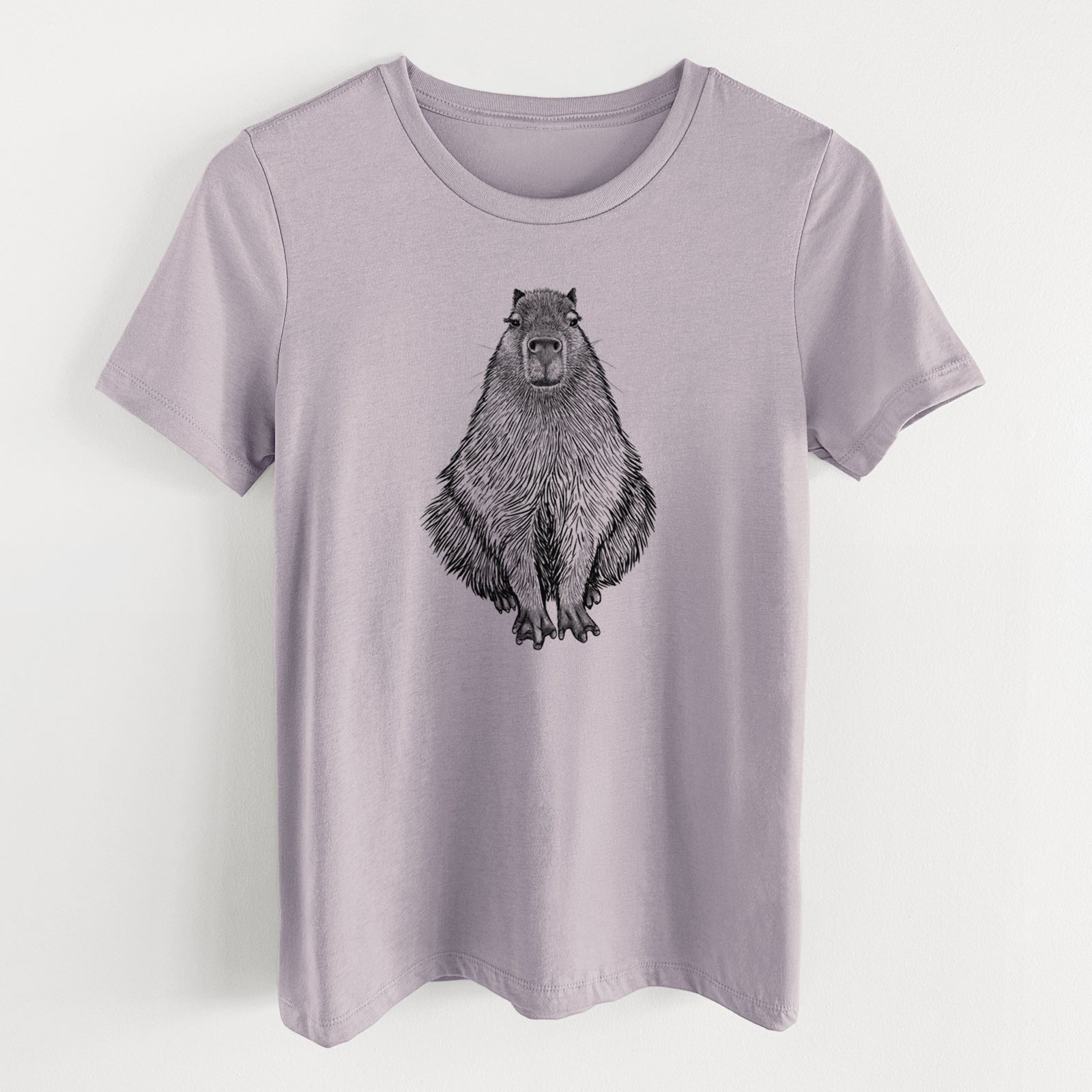 Light violet women's relaxed fit cotton t-shirt laid flat, printed with a detailed black ink illustration of a capybara sitting and facing forward.