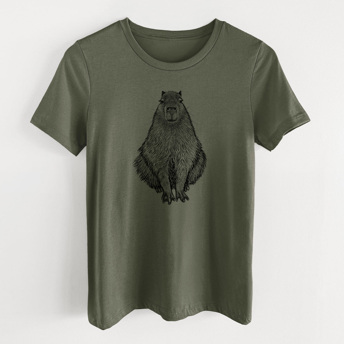 Military green women's relaxed fit cotton t-shirt laid flat, printed with a detailed black ink illustration of a capybara sitting and facing forward.