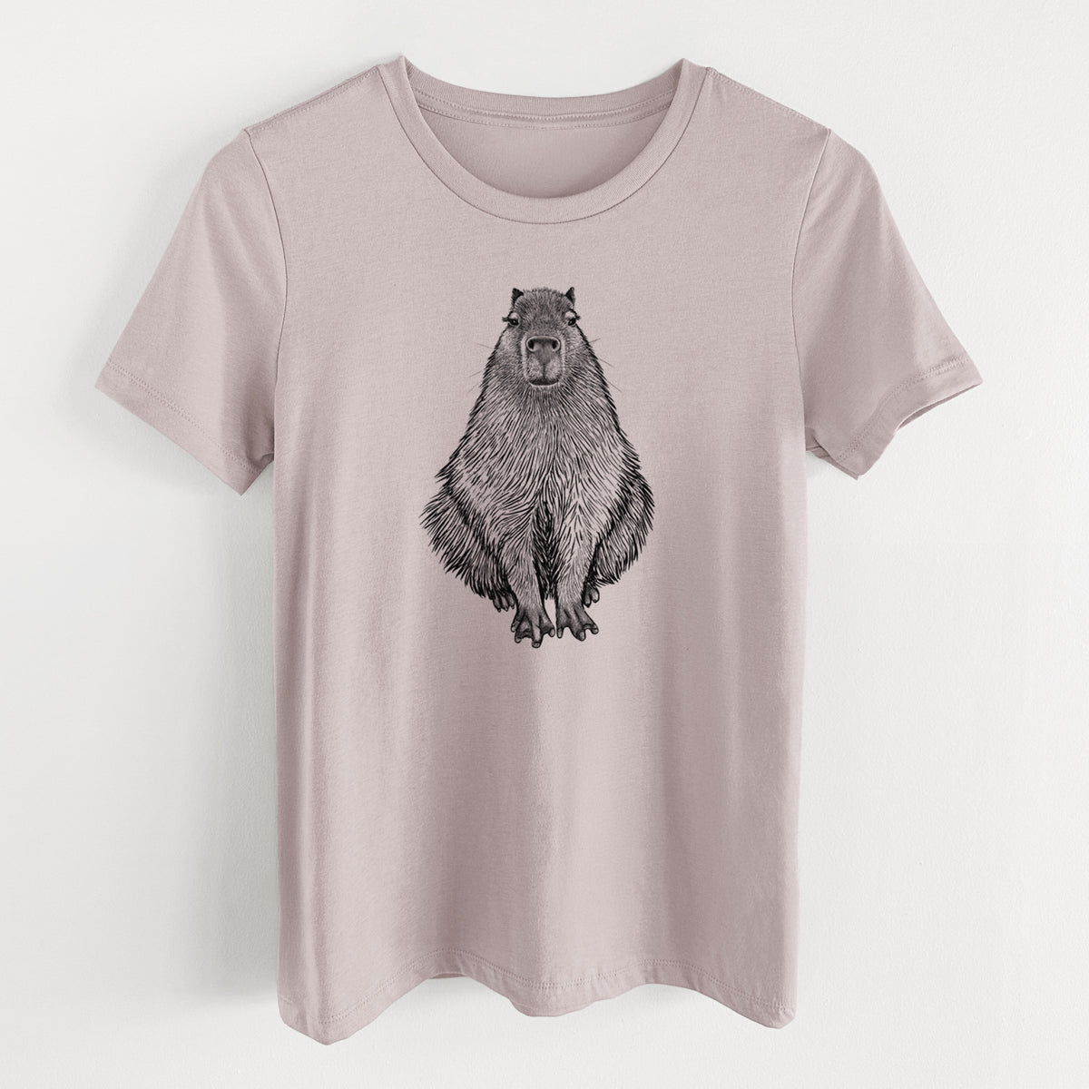Pink gravel women's relaxed fit cotton t-shirt laid flat, printed with a detailed black ink illustration of a capybara sitting and facing forward.