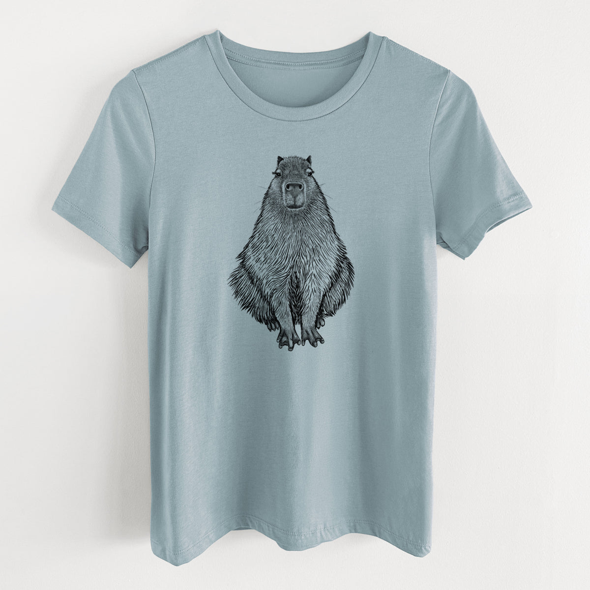 Vintage denim women's relaxed fit cotton t-shirt laid flat, printed with a detailed black ink illustration of a capybara sitting and facing forward.