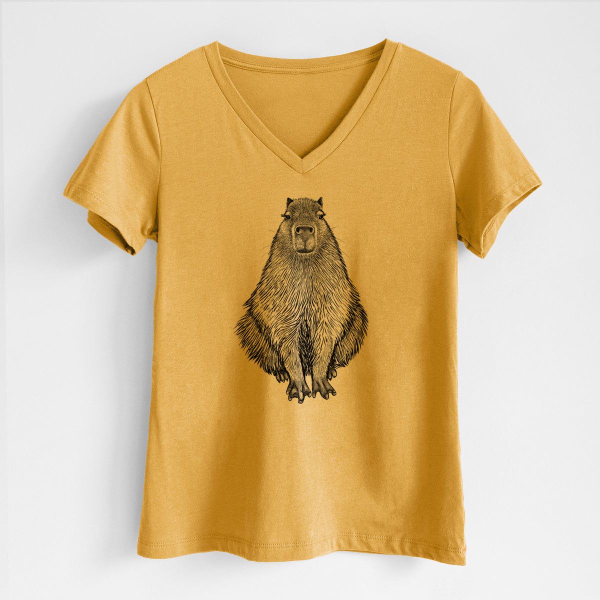 Honeycomb yellow women's relaxed fit cotton V-neck t-shirt laid flat, printed with a detailed black ink illustration of a capybara sitting and facing forward.