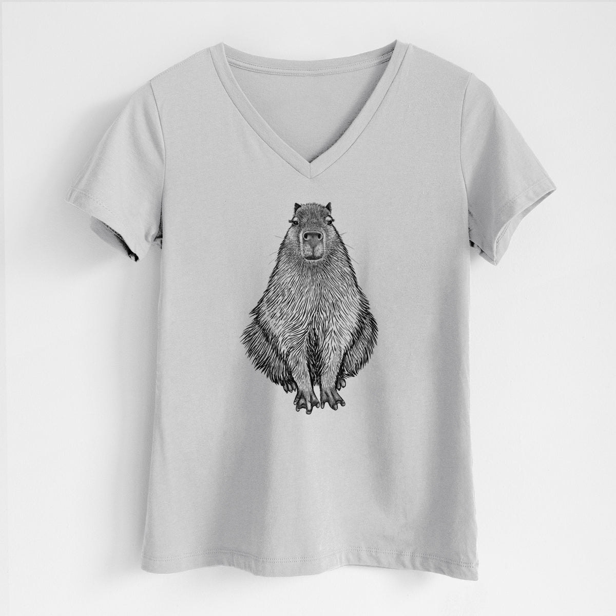 Lunar grey women's relaxed fit cotton V-neck t-shirt laid flat, printed with a detailed black ink illustration of a capybara sitting and facing forward.