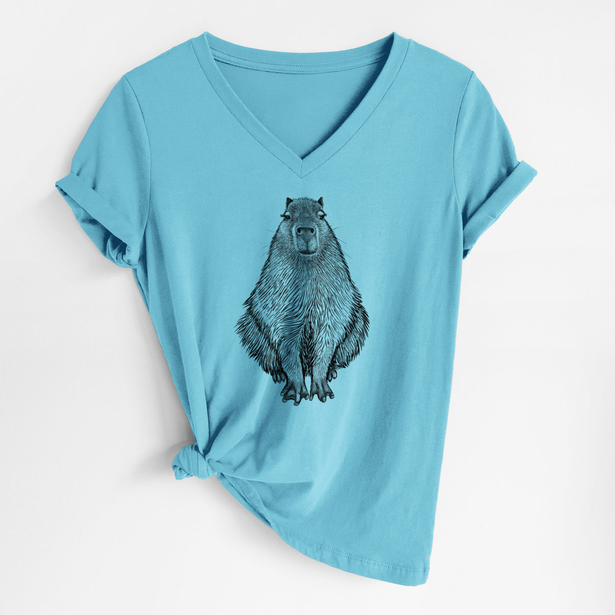 Turquoise women's relaxed fit cotton V-neck t-shirt laid flat, printed with a detailed black ink illustration of a capybara sitting and facing forward.