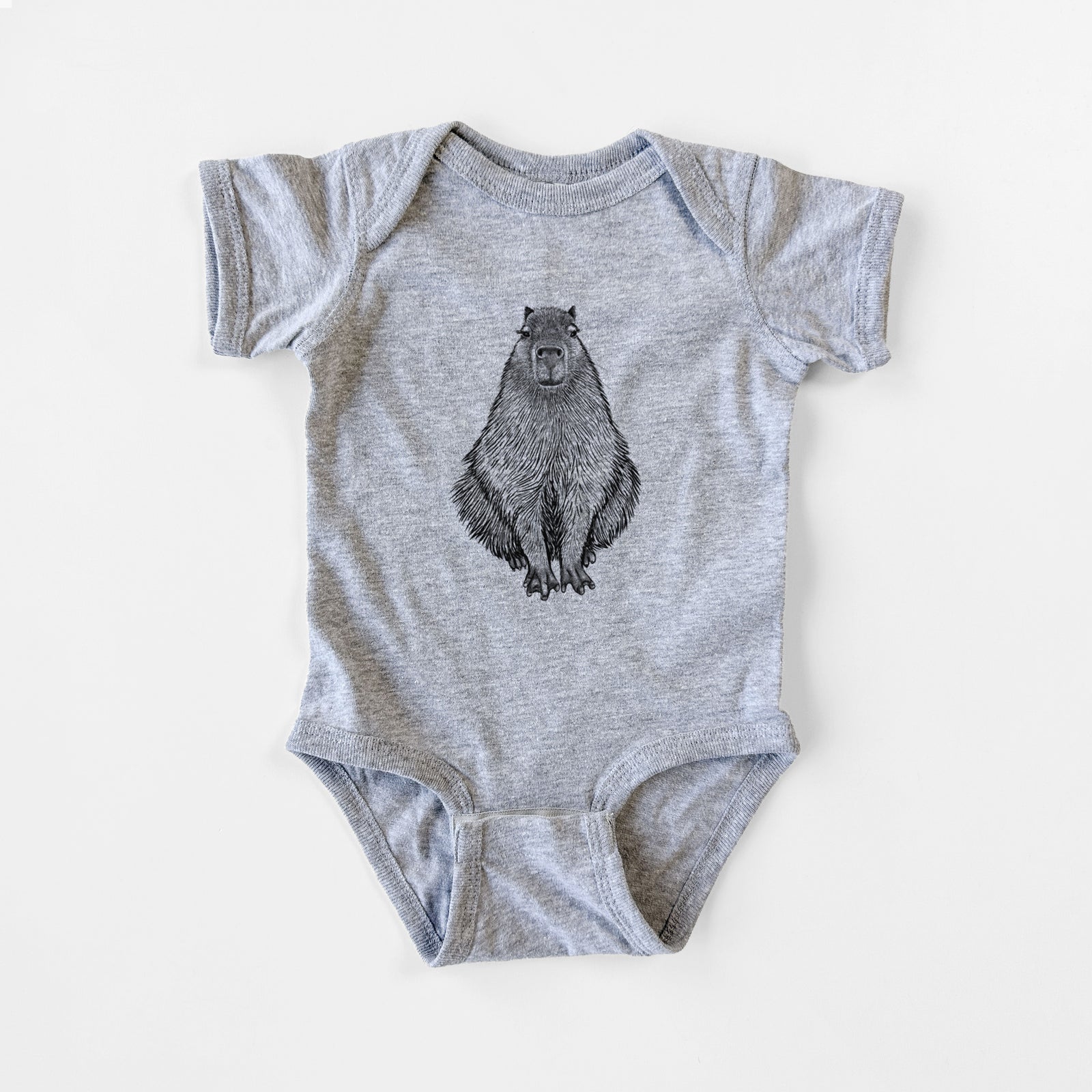 Grey baby bodysuit laid flat, printed with a detailed black ink illustration of a capybara sitting and facing forward.