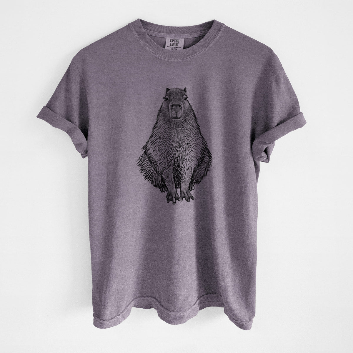 Wine red Comfort Colors t-shirt laid flat, printed with a detailed black ink illustration of a capybara sitting and facing forward.