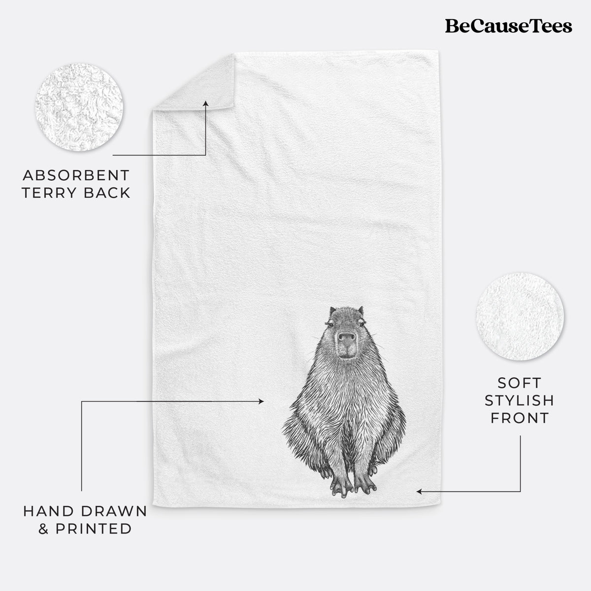 White hand towel printed with a detailed black ink illustration of a capybara sitting and facing forward.